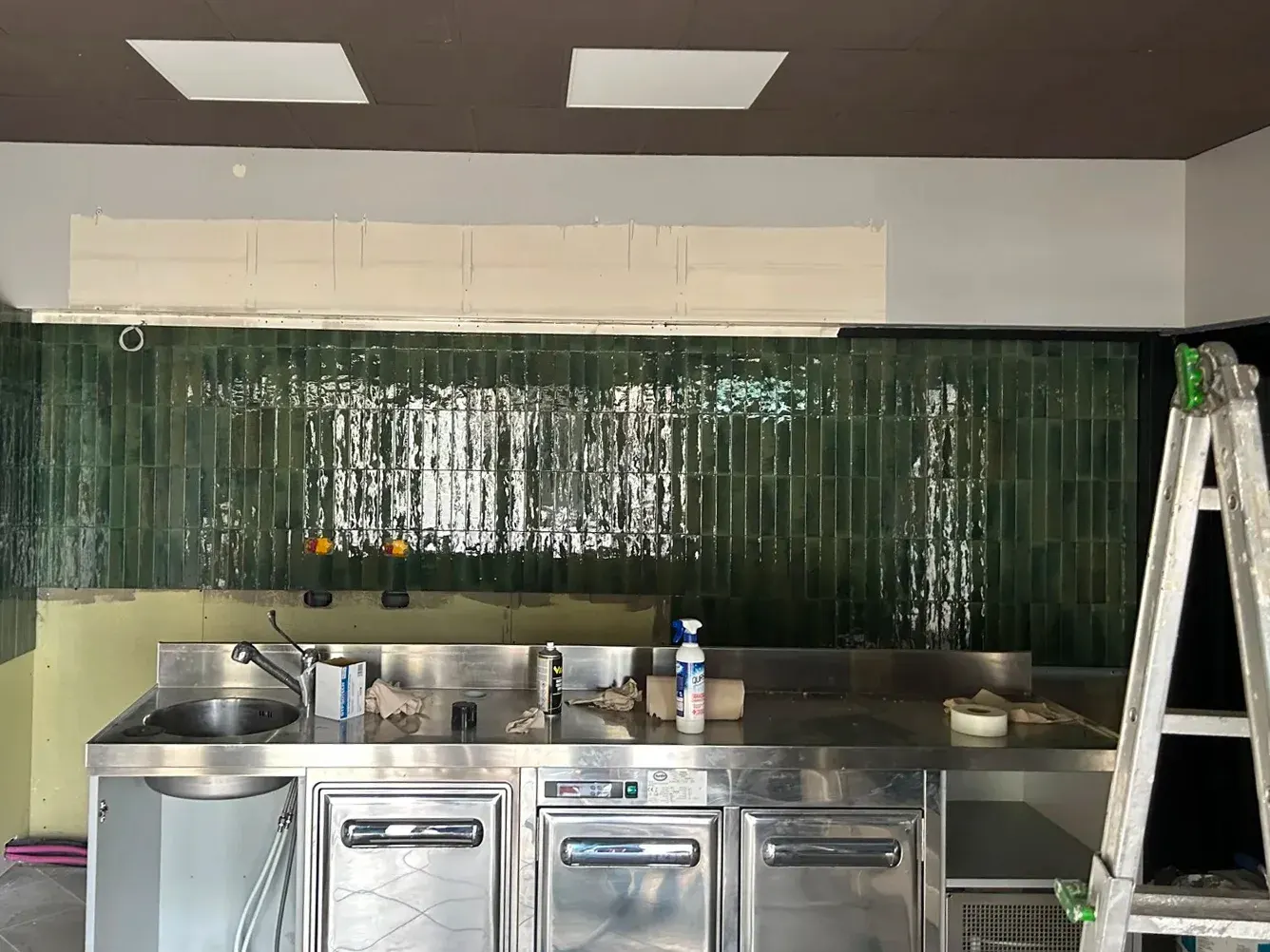 The Dispenseria building site with its green tiled wall
